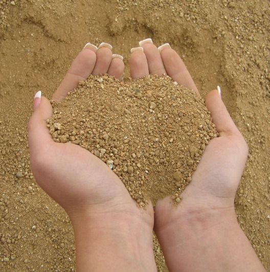 A balance of native material and clay (also known as decomposed granite) that is designed for a wide range of applications including: baseball/softball infields, running tracks, bike paths, walking and riding paths. dog runs, horse stalls, driveway and paver base. The materials "reddish-tan" color makes for excellent landscape ground cover applications.